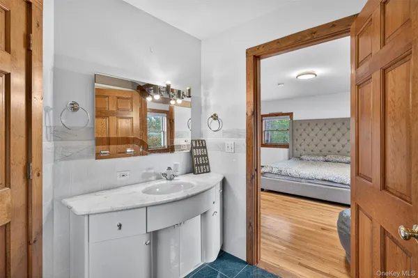 a en suite bathroom with a sink a mirror and a shower