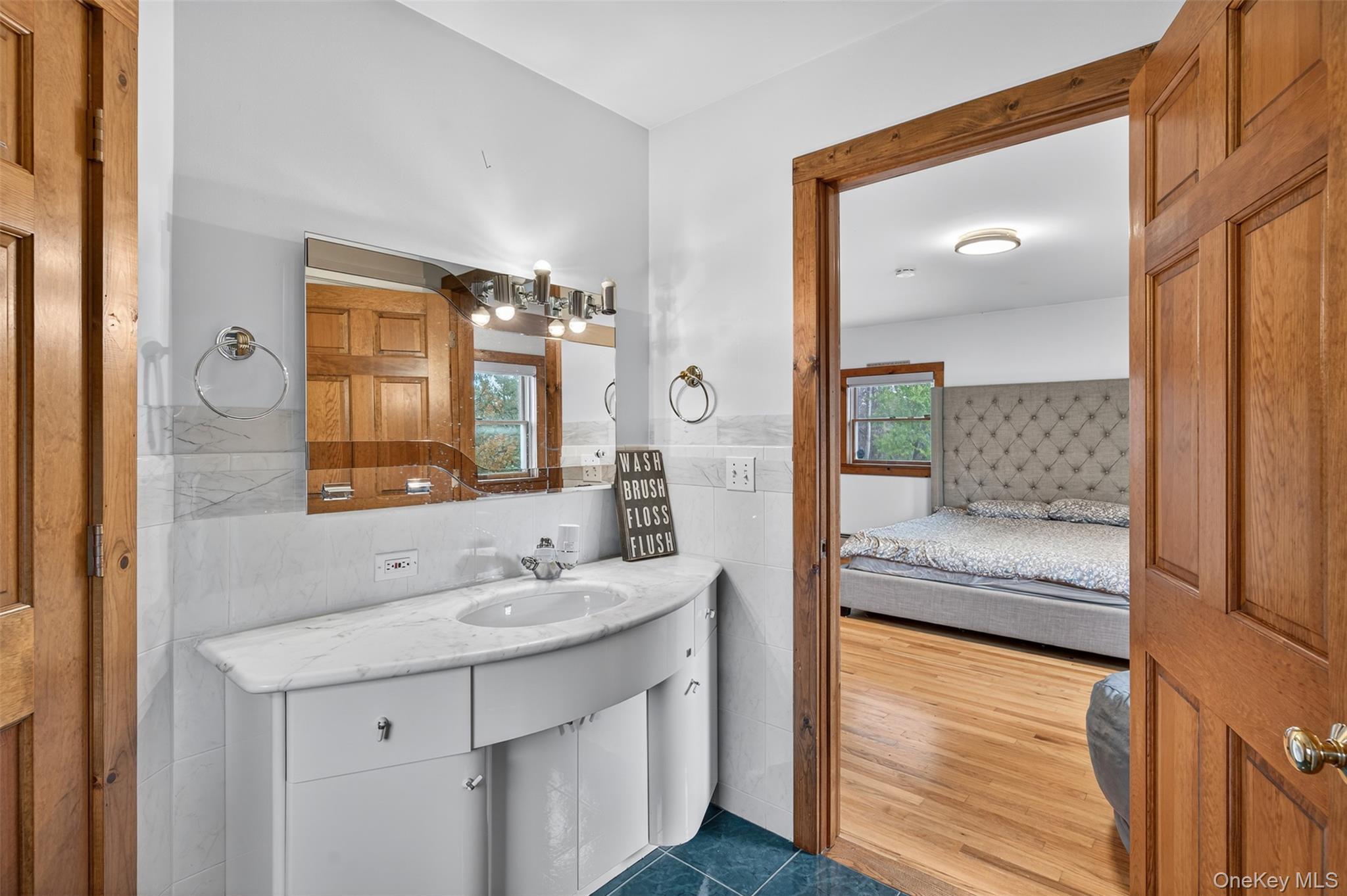 158 Wade Road Liberty, NY 12754 - Photo 14 of 34 a en suite bathroom with a sink a mirror and a shower