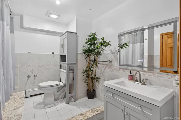 a bathroom with a sink a toilet and a mirror