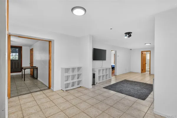 a view of a livingroom with wooden floor and a flat screen tv