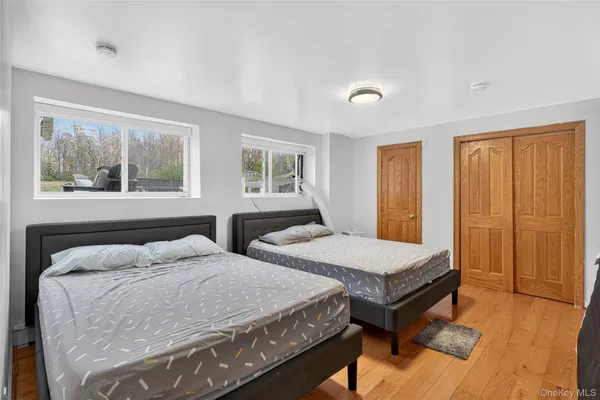 a bedroom with two beds and a window