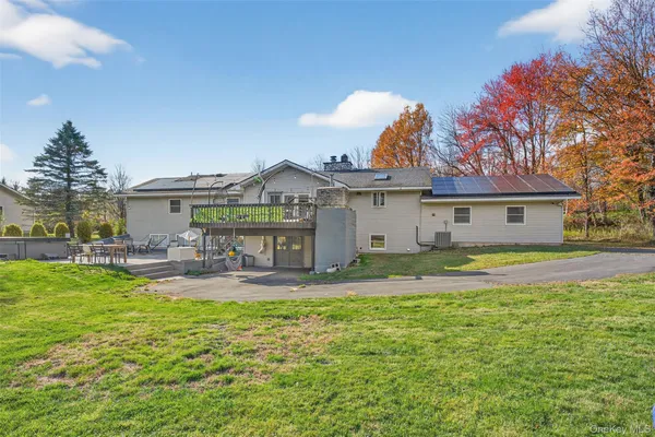 a view of a house with swimming pool and a yard