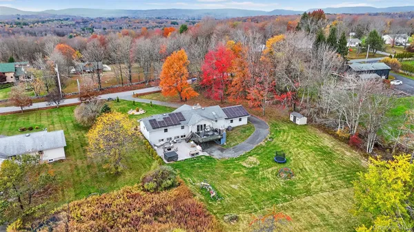 an aerial view of a house with a yard basket ball court