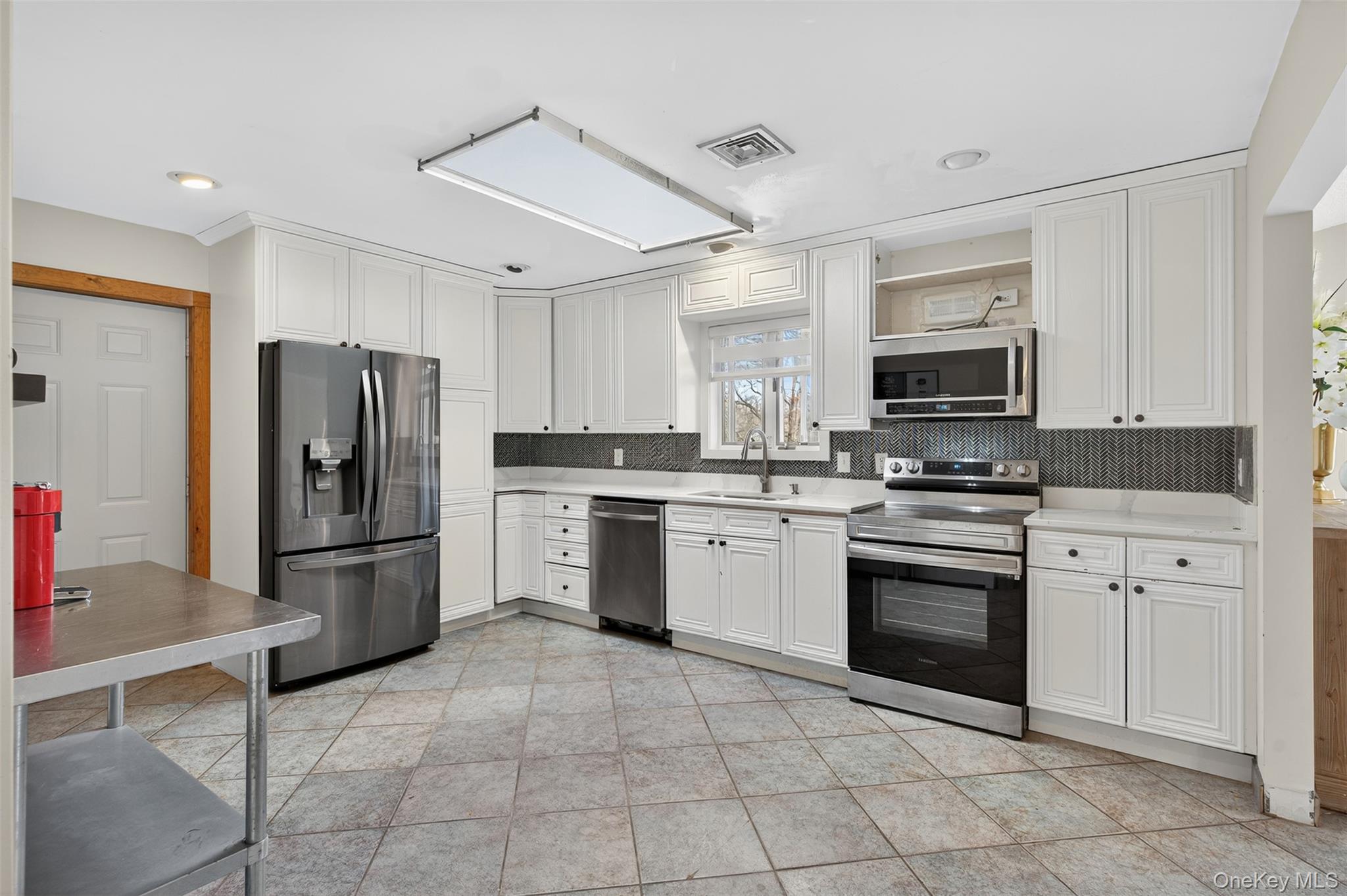 158 Wade Road Liberty, NY 12754 - Photo 8 of 34 a kitchen with cabinets stainless steel appliances and a window