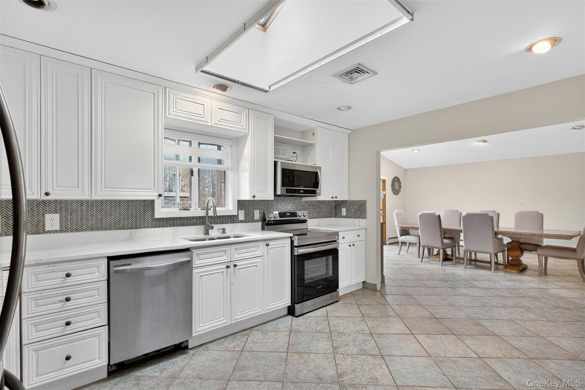 158 Wade Road Liberty, NY 12754 - Photo 9 of 34 a kitchen with white cabinets and appliances
