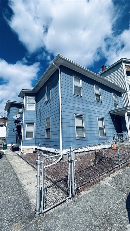 a brick house with table and chairs in front of it