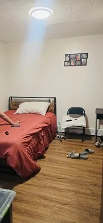 a bedroom with two bed and a night stand