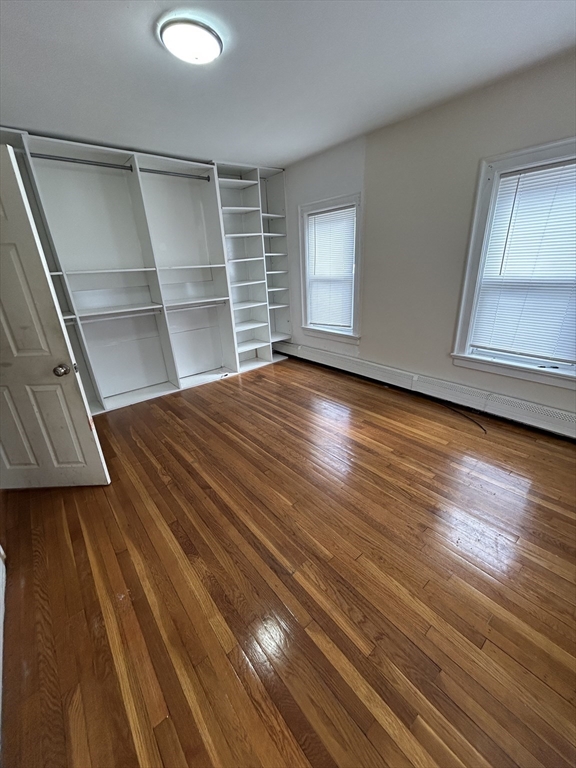 5 Palmer Street, Unit 1 Worcester, MA 01605 - Photo 3 of 9 a view of empty room with wooden floor and window
