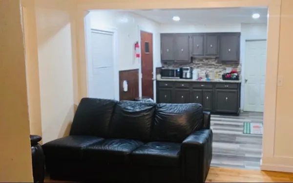 a living room with furniture and kitchen view