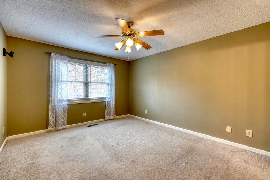 241 12 Point Road Blairsville, GA 30512 - Photo 13 of 34 an empty room with windows and chandelier fan