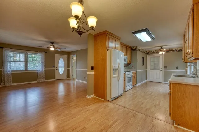 a view of a kitchen with furniture and wooden floor