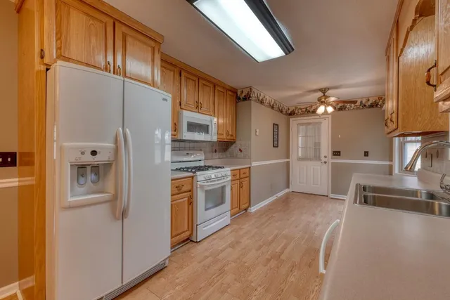 a kitchen with stainless steel appliances a refrigerator sink and stove