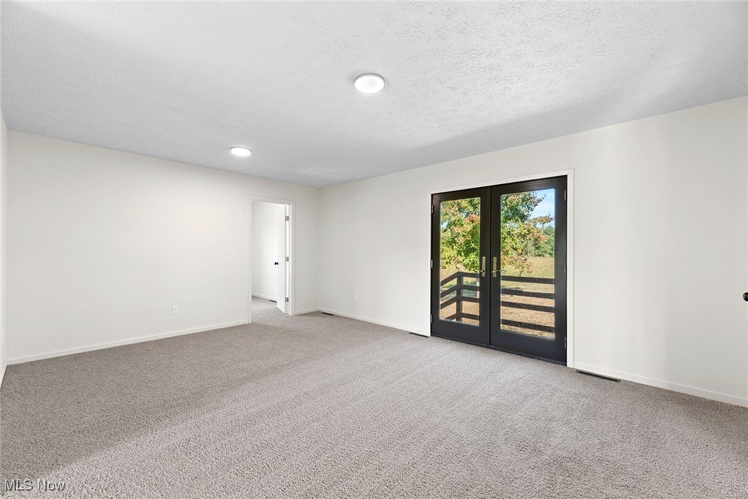 2236 Hartville Road Mogadore, OH 44260 - Photo 16 of 50 Carpeted spare room with french doors and a textured ceiling