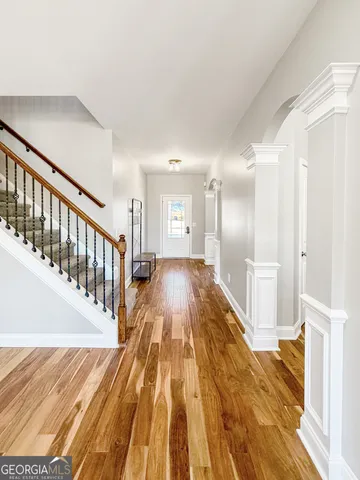 a view of a room with wooden floor and a ceiling fan