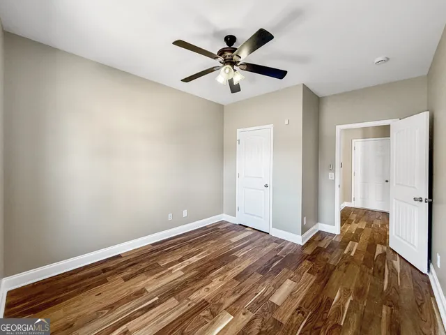 a view of an empty room with window and a fireplace