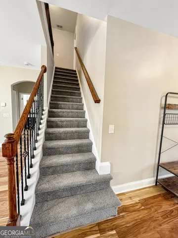 a spacious bathroom with a vanity a sink a mirror and a bathtub