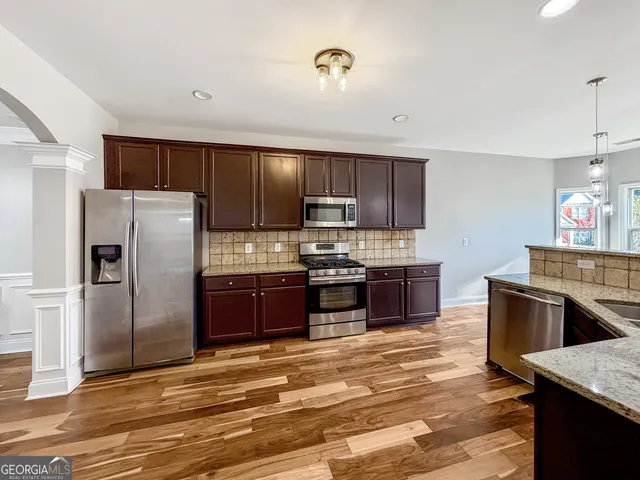 a view of a dining room with furniture wooden floor and chandelier