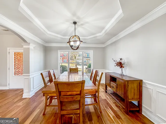 a dining room with furniture and wooden floor