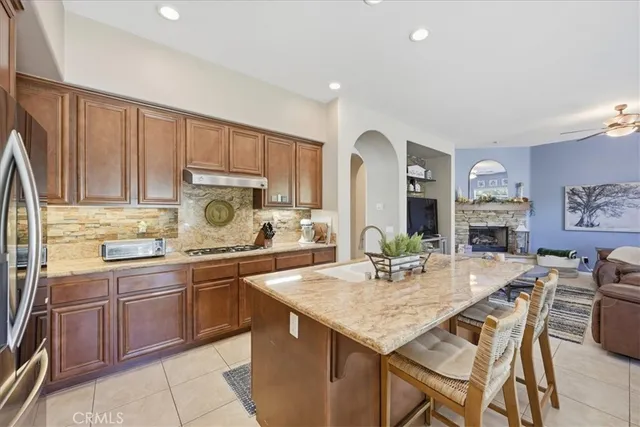 a kitchen with a stove a sink a dining table and chairs