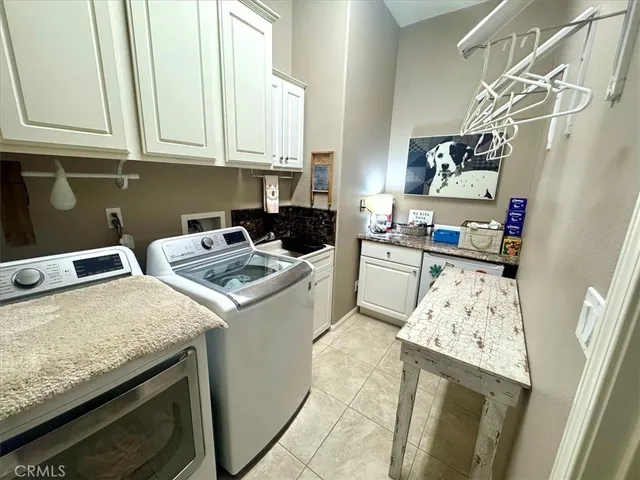 a kitchen with a sink a stove and cabinets