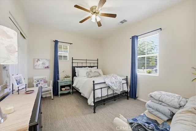 a bed room with a bed and a chair