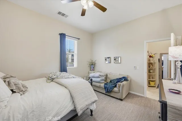 a bedroom with a bed gym equipment and a large window