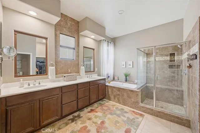 a spacious bathroom with a double vanity sink toilet mirror and bathtub
