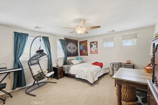 a bedroom with furniture and a gym equipment