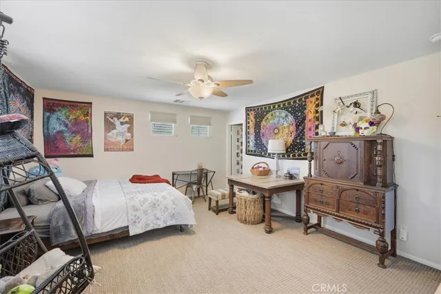 a bedroom with furniture and a painting on the wall