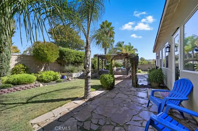 a view of a chair and table in backyard
