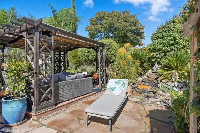 a view of a patio with table and chairs and potted plants