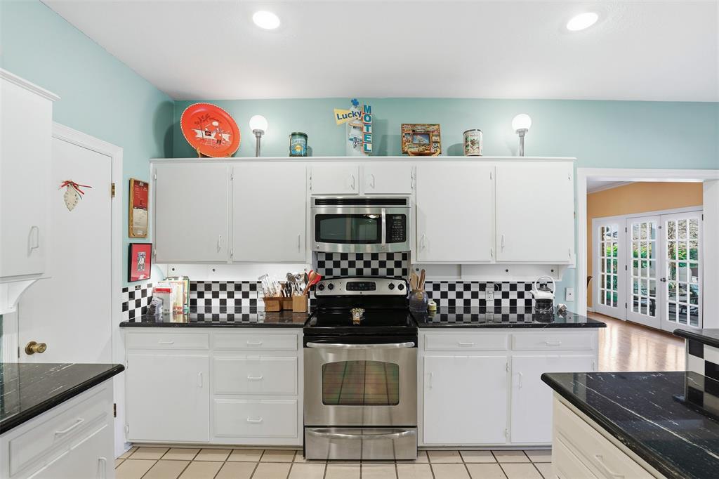 3800 Hollow Creek Road Benbrook, TX 76116 - Photo 11 of 29 a kitchen with a stove a refrigerator and a stove