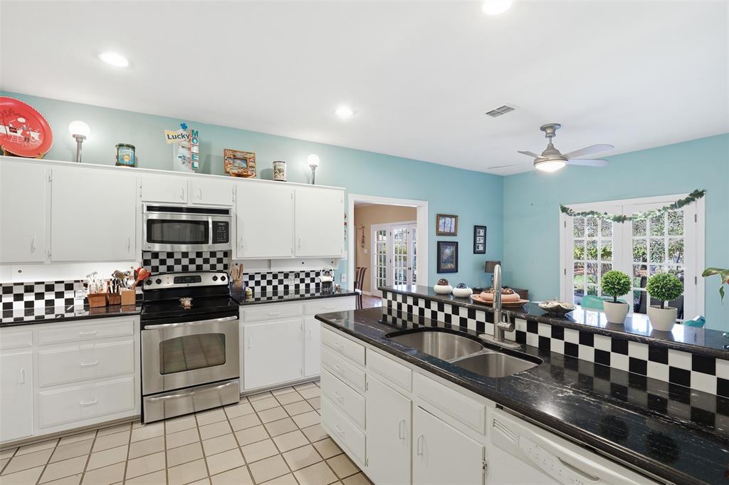 3800 Hollow Creek Road Benbrook, TX 76116 - Photo 12 of 29 a kitchen with granite countertop a sink a stove and cabinets