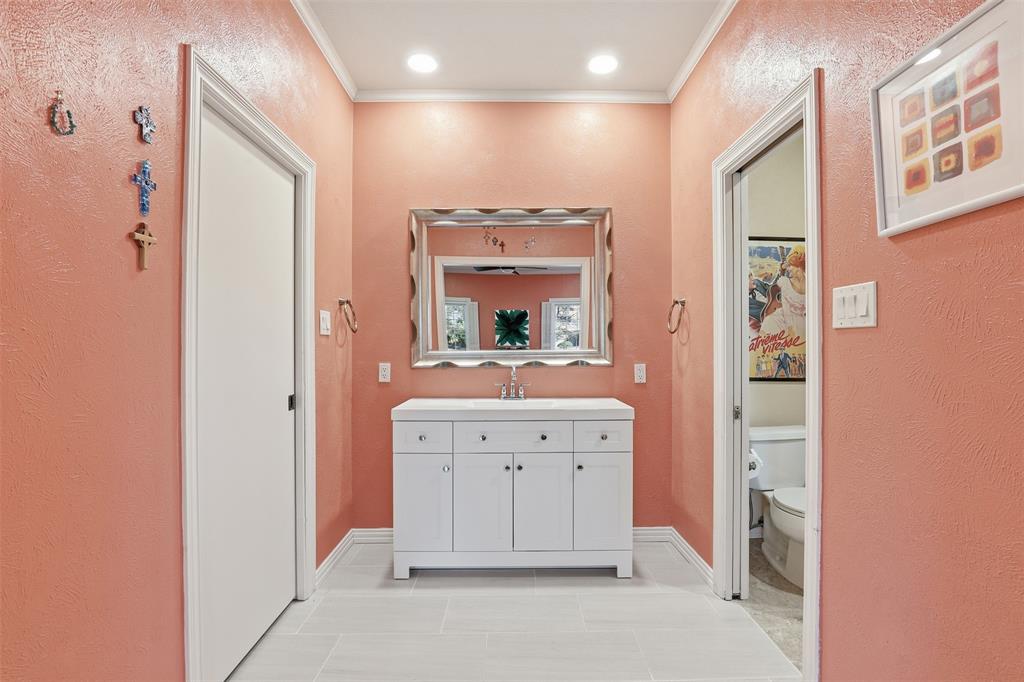 3800 Hollow Creek Road Benbrook, TX 76116 - Photo 19 of 29 a bathroom with a mirror sink and vanity