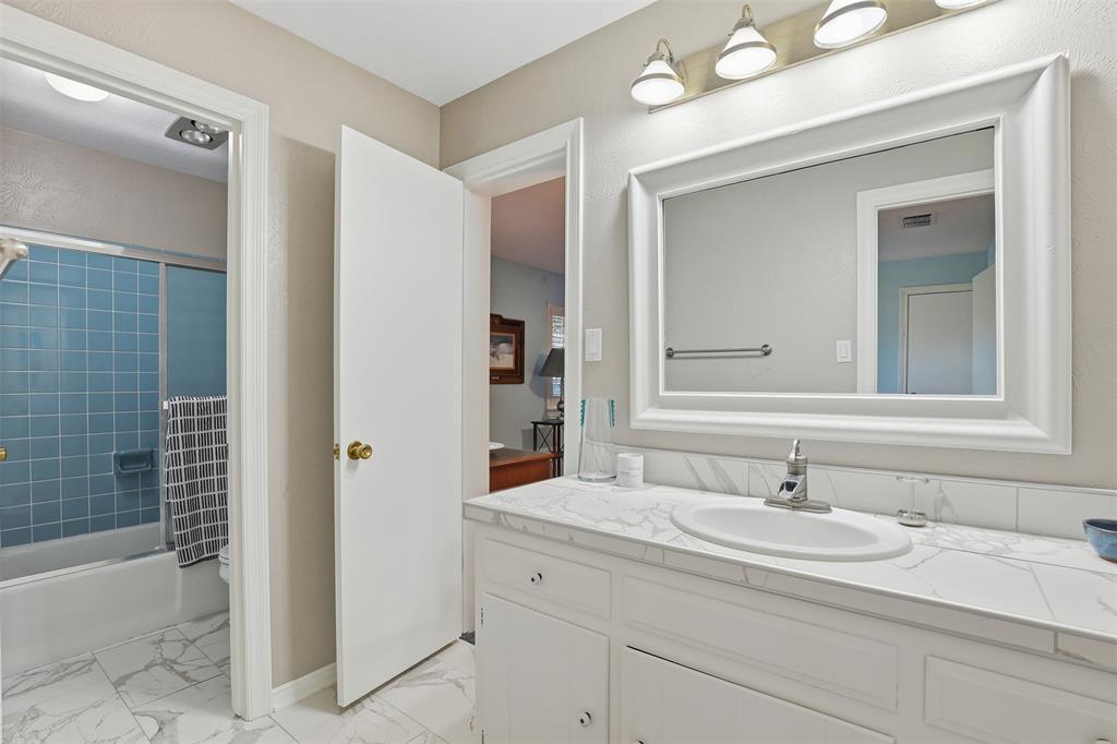 3800 Hollow Creek Road Benbrook, TX 76116 - Photo 22 of 29 a bathroom with a granite countertop sink and a mirror