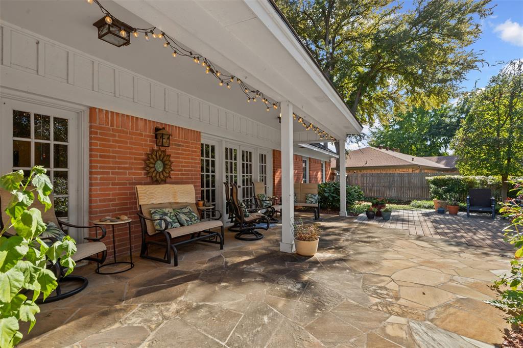 3800 Hollow Creek Road Benbrook, TX 76116 - Photo 24 of 29 a view of a patio with table and chairs under an umbrella