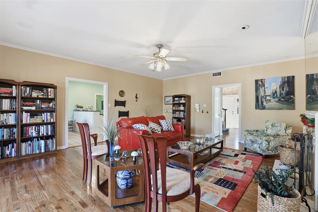 3800 Hollow Creek Road Benbrook, TX 76116 - Photo 8 of 29 a living room with furniture a bookshelf and a window