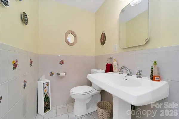 a bathroom with a sink mirror and toilet