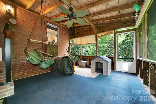 a view of a porch with furniture and a backyard
