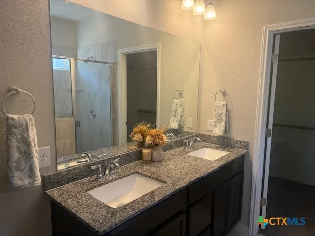 a bathroom with a shower and a glass door