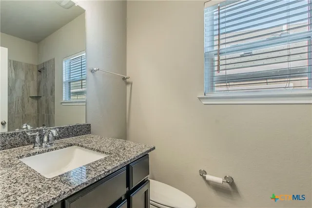a bathroom with a shower and a sink