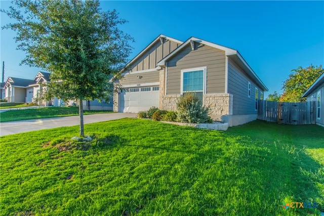 a view of a house with a backyard