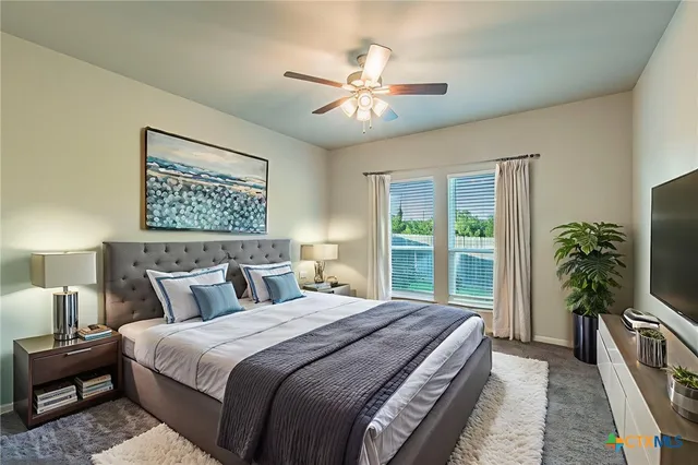 a bedroom with a large bed and a chandelier