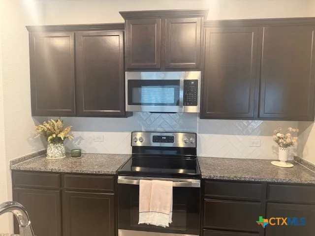 a kitchen with a sink and a microwave