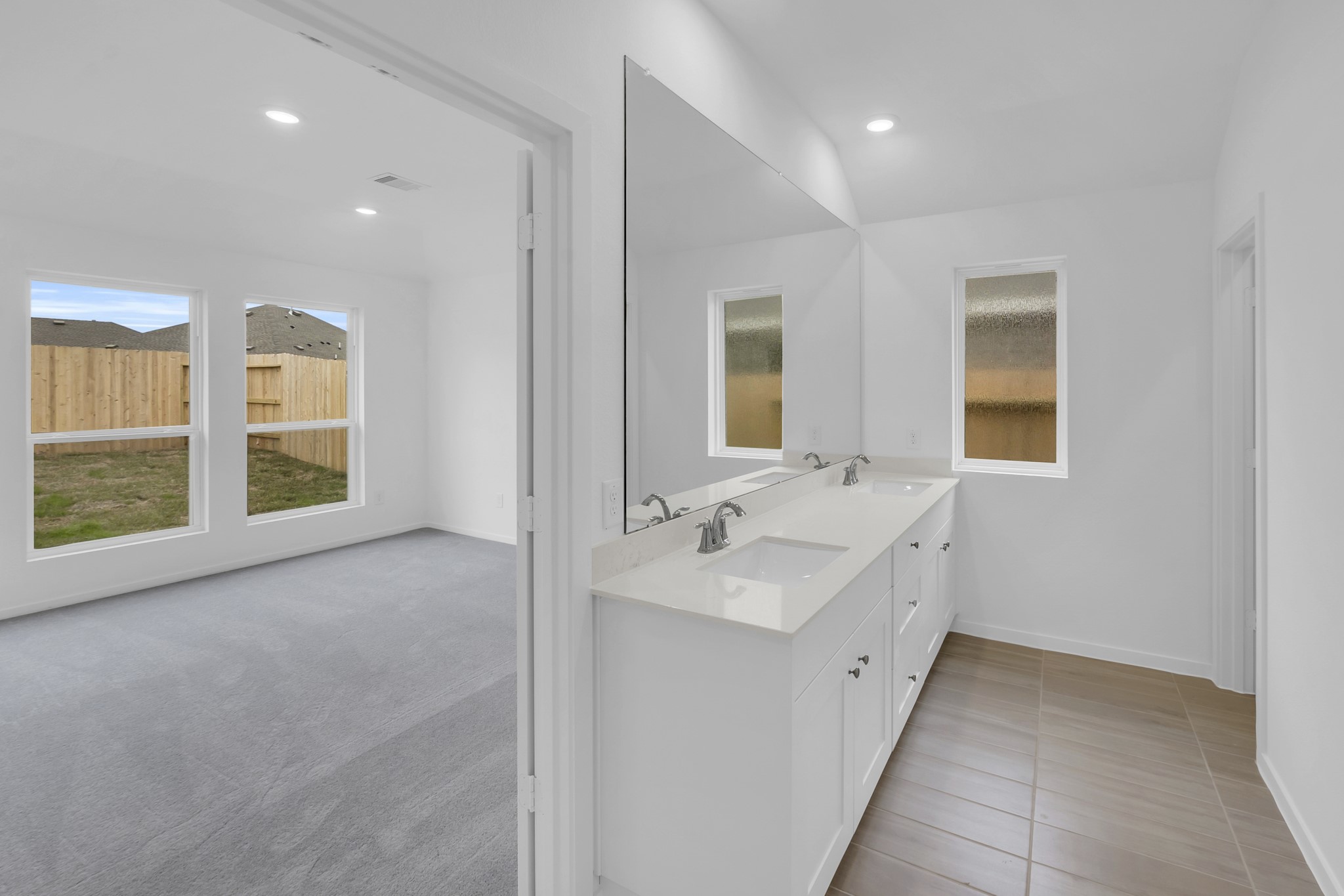 2135 Mosaic Vly Court Angleton, TX 77515 - Photo 5 of 15 a view of a bathroom with two sinks and a bathtub