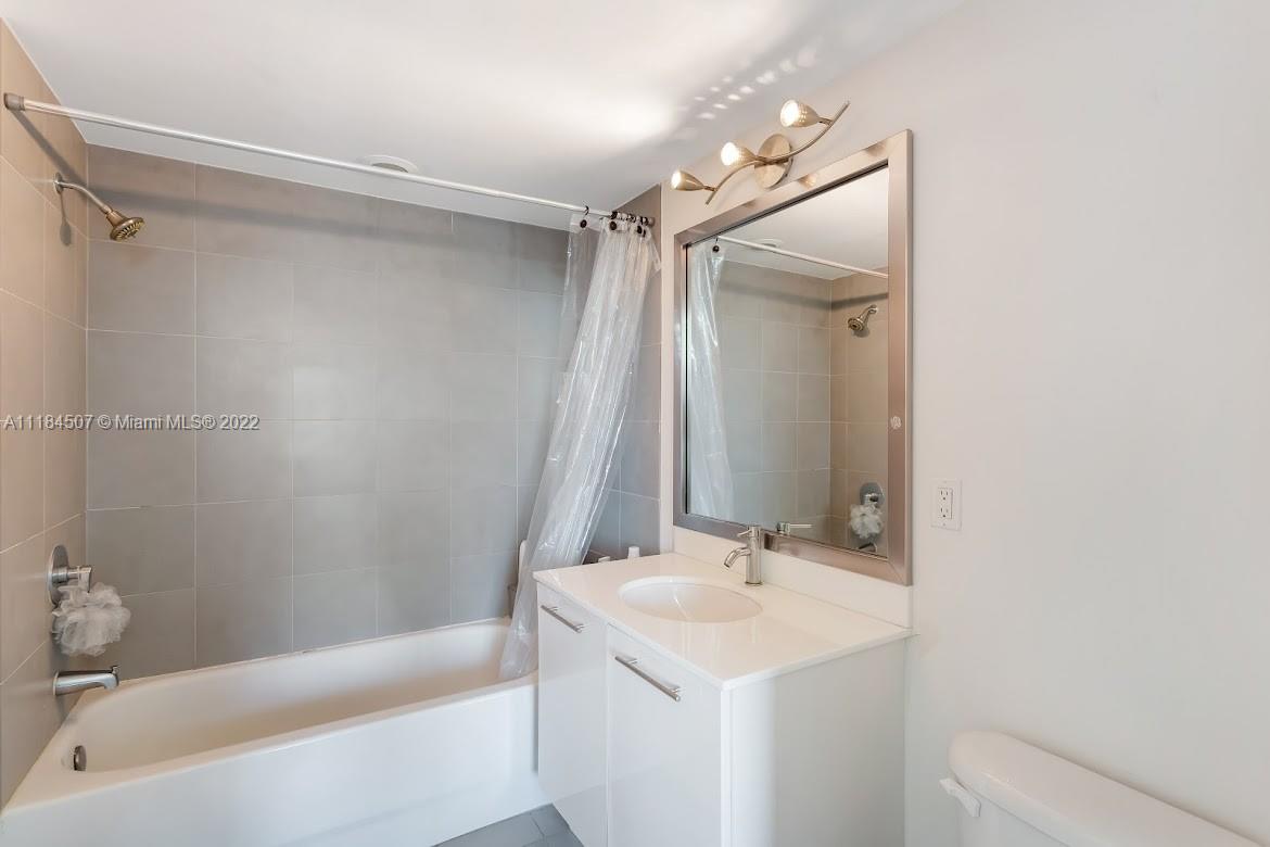 92 Southwest 3rd Street, Unit 2003 Miami, FL 33130 - Photo 20 of 30 a bathroom with a sink a toilet and shower