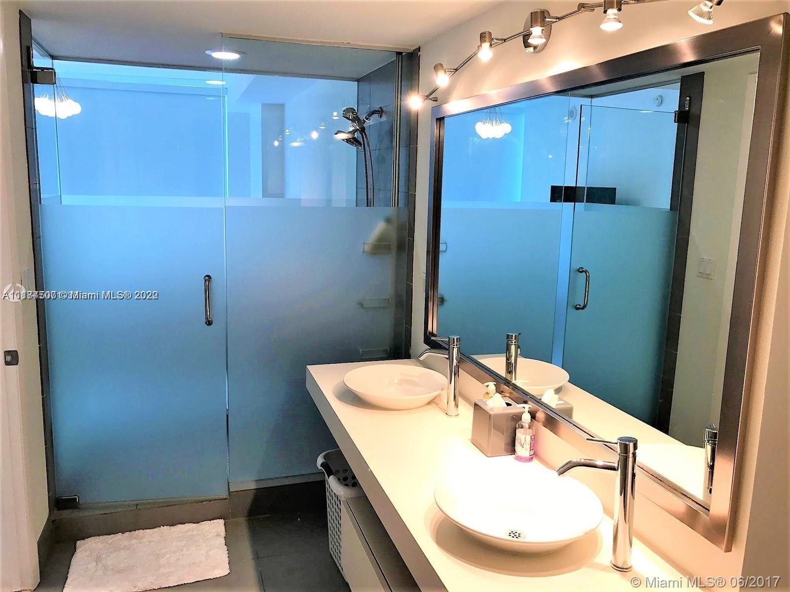 92 Southwest 3rd Street, Unit 2003 Miami, FL 33130 - Photo 23 of 30 a bathroom with a sink a toilet and shower