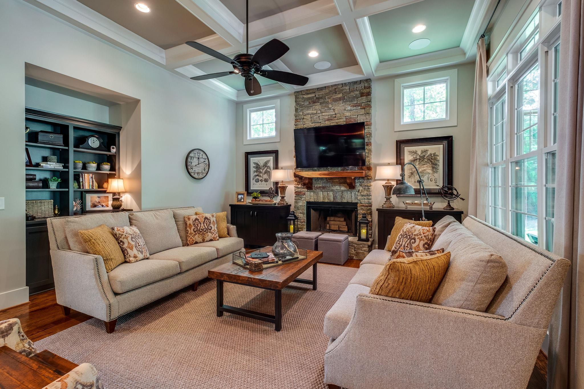Large Great Room w/ Stacked Stone Fireplace & Coffered Ceilings