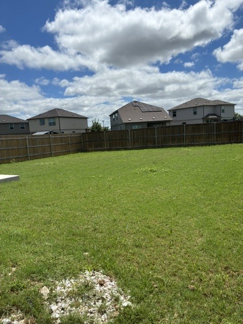 233 Perfect World Loop Jarrell, TX 76537 - Photo 18 of 24 A spacious, verdant yard awaits outdoor enjoyment with room for recreation and future landscaping.