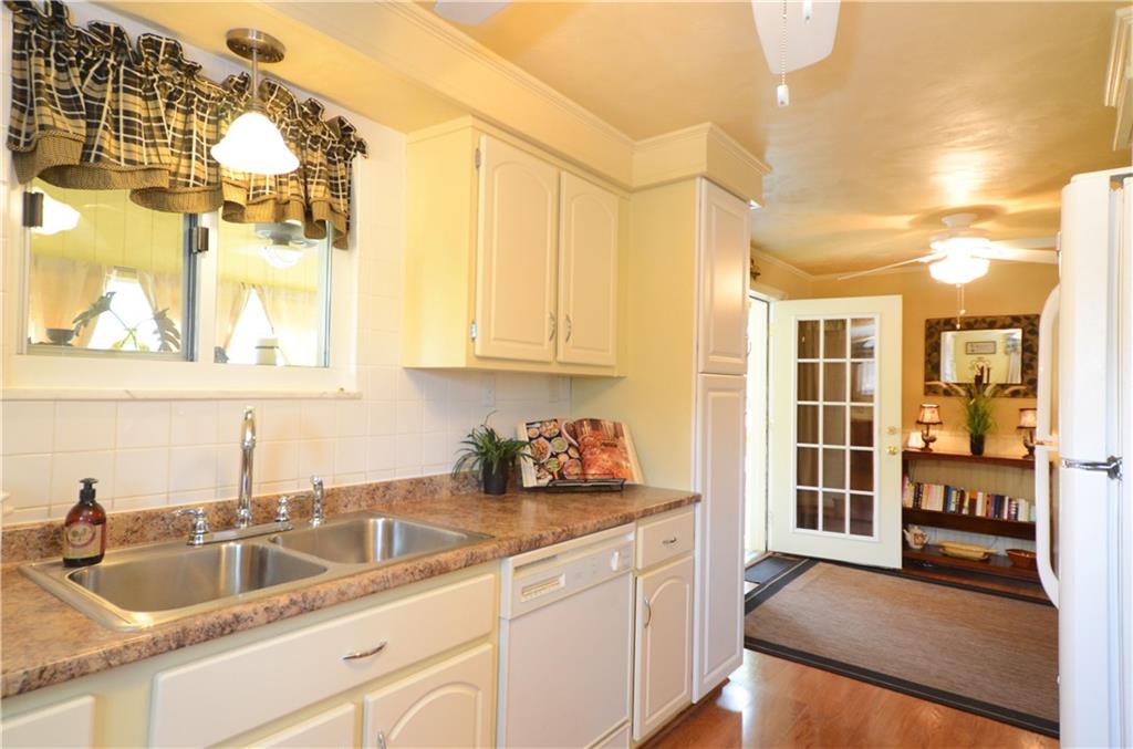 2209 North Forest Grove Road Coraopolis, PA 15108 - Photo 5 of 25 View of the kitchen from the side entry into the breakfast area. French doors lead to the 4 season room. Laminate flooring, gas stove, refrigerator, built-in microwave all included.